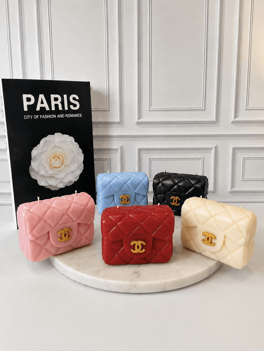 Hand-sculpted quilted handbag candle with gold clasp in pink, red, white, black, and blue