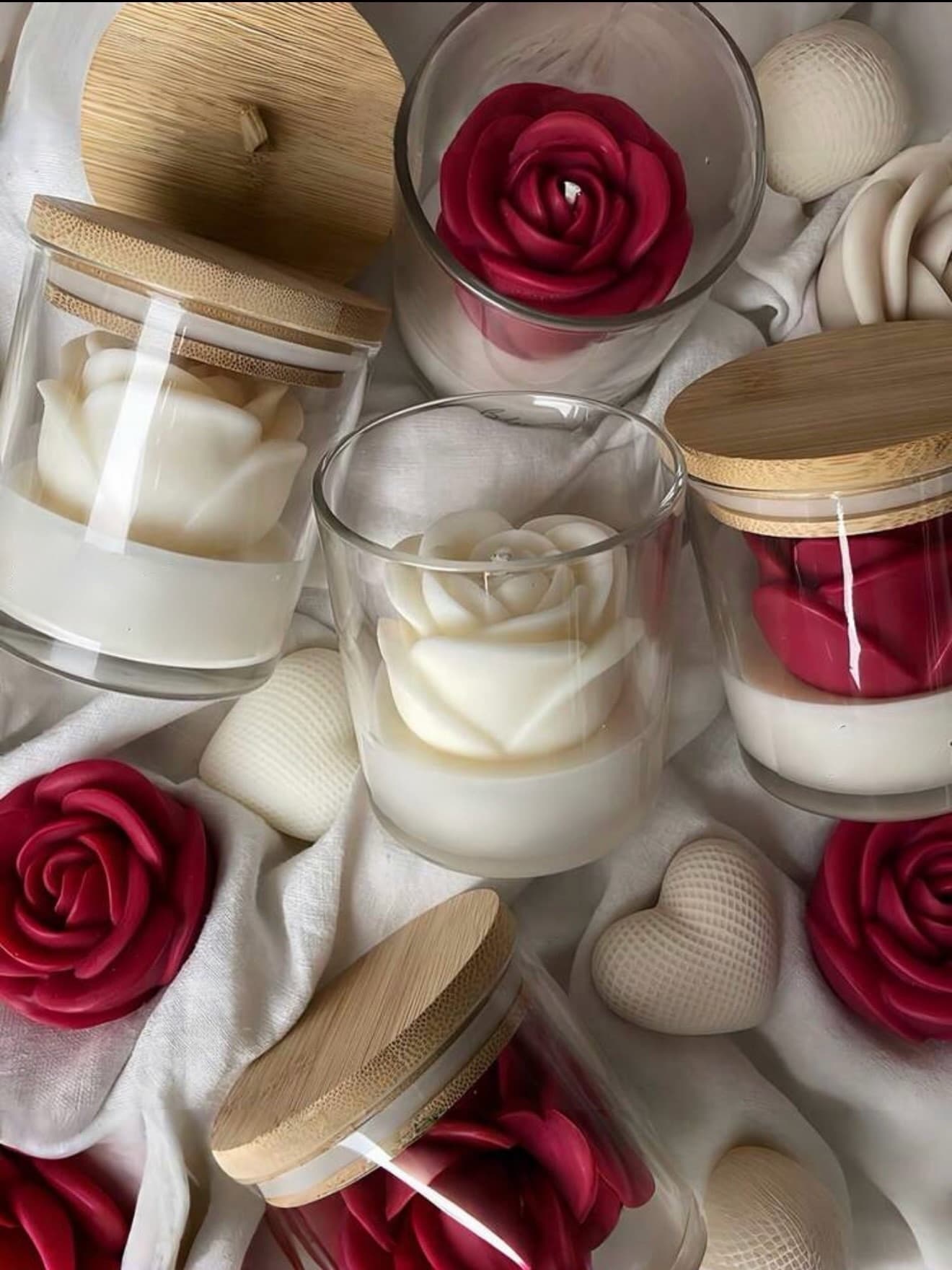 Sculpted rose candle in a glass jar with bamboo lid, in red and ivory