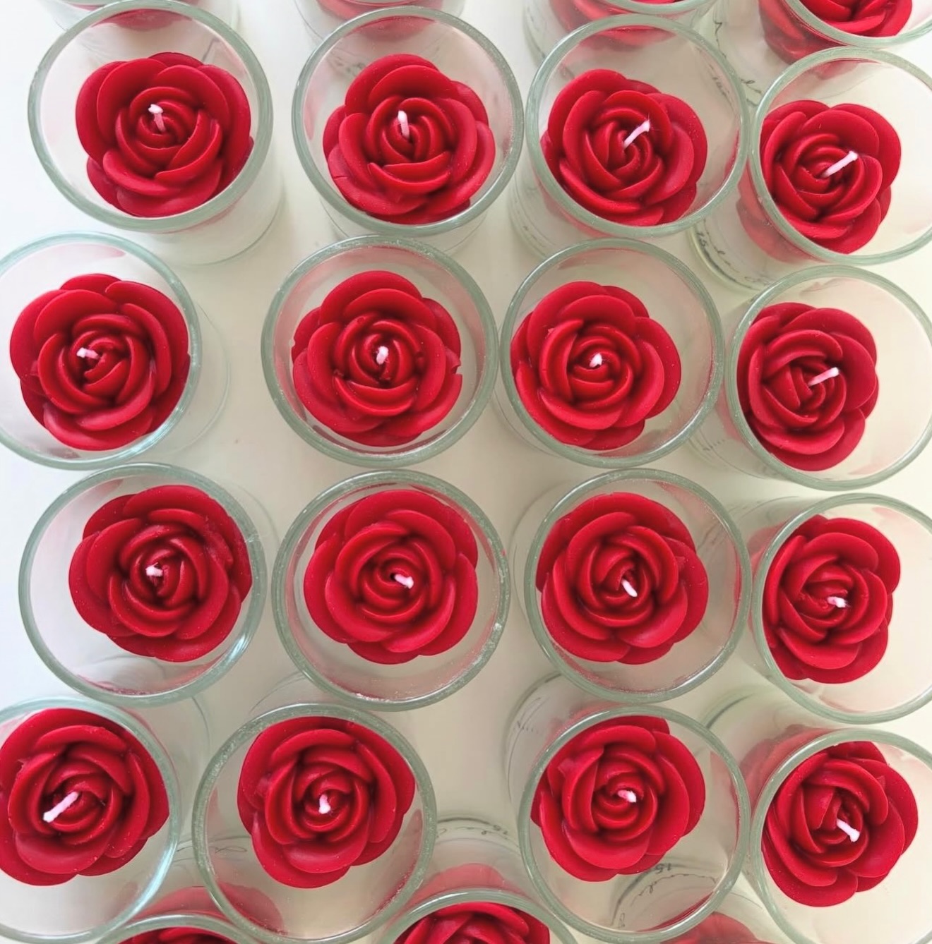 Red rose candles in glass votives, top-down